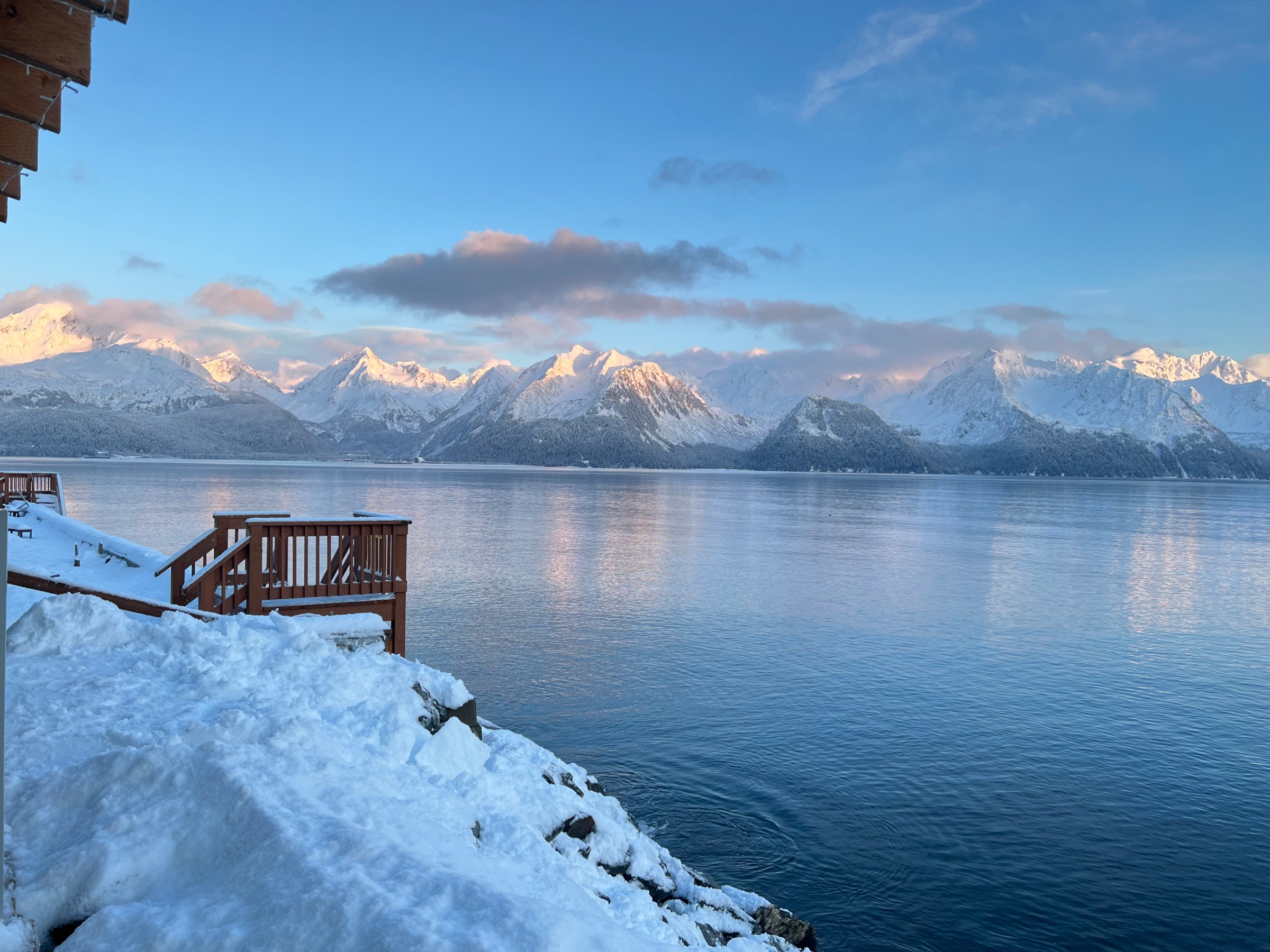a person riding a wave on top of a snow covered mountain