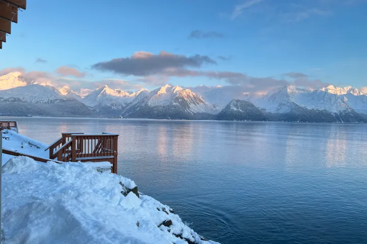 a person riding a wave on top of a snow covered mountain