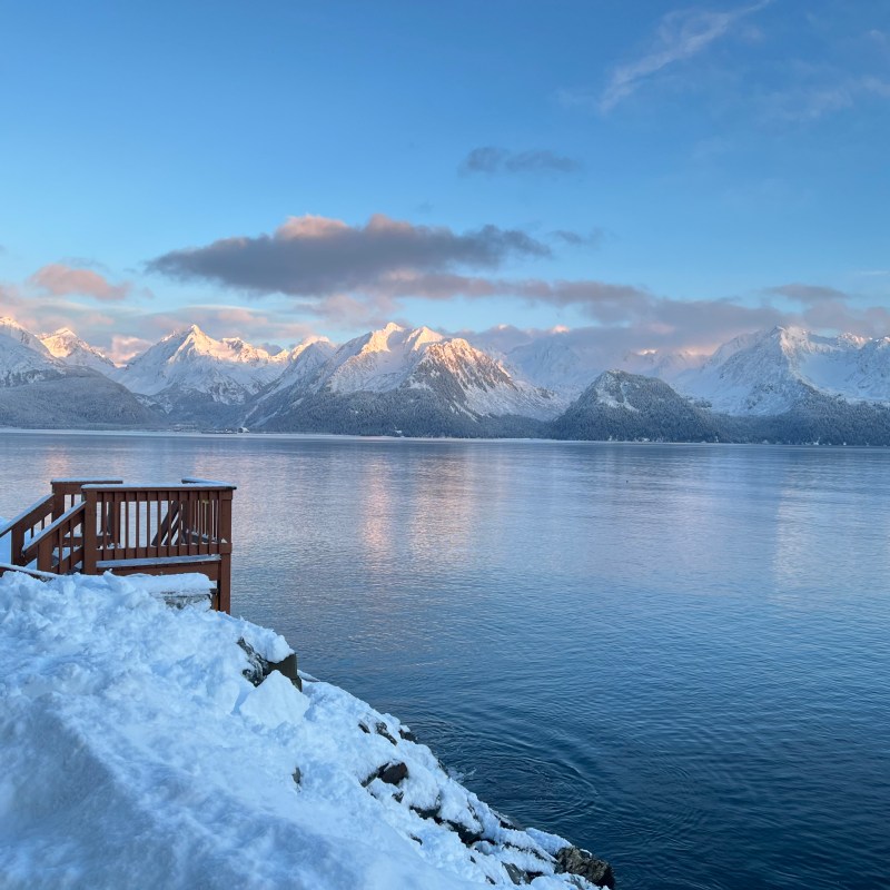 a person riding a wave on top of a snow covered mountain
