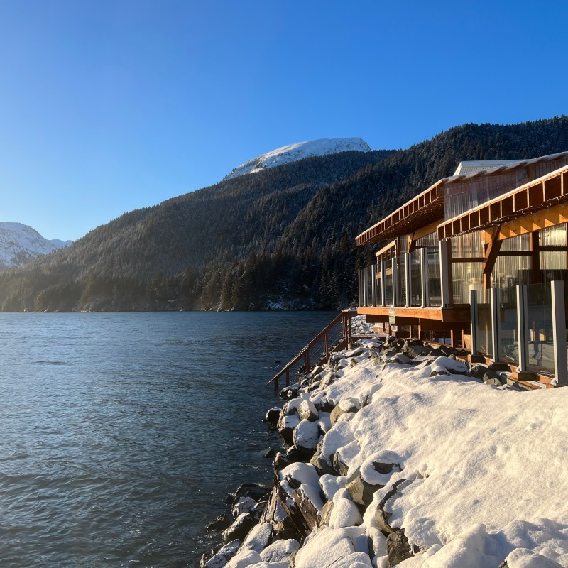a building with a mountain in the snow