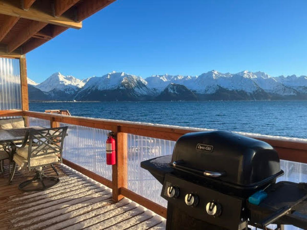 a boat sitting on top of a wooden bench overlooking a body of water