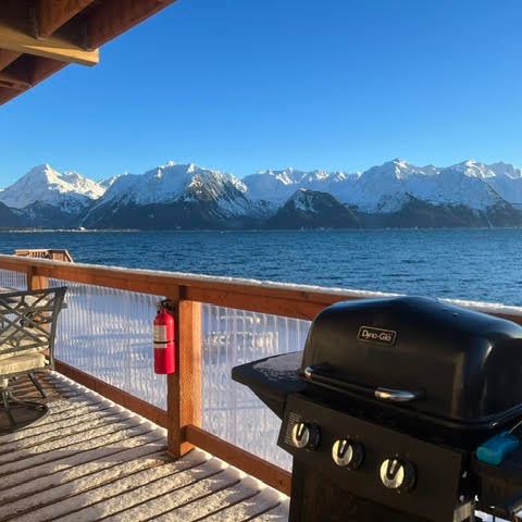 a boat sitting on top of a wooden bench overlooking a body of water