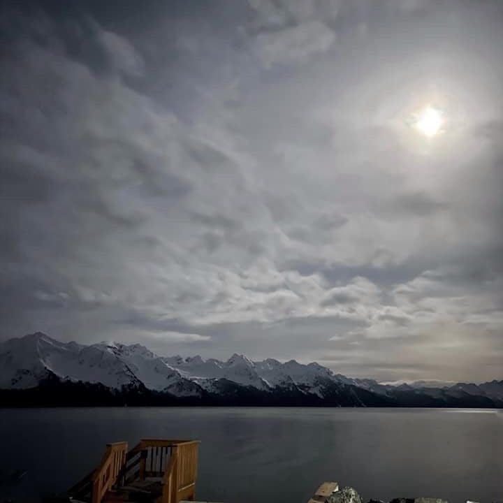 a group of clouds in the sky over a body of water