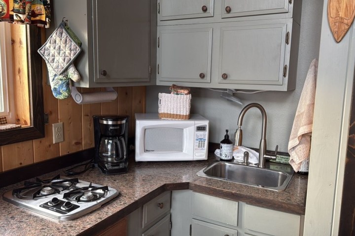 a stove top oven sitting inside of a kitchen