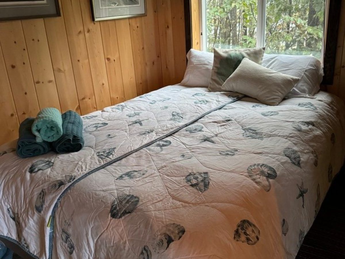 a bedroom with a bed and a window